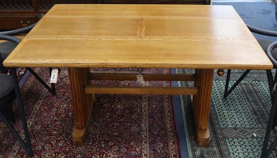 An Art Deco 1920s oak extending dining table L.137cm